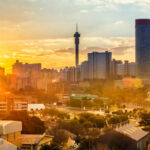 Johannesburg cityscape, taken at sunset, showing Hillbrow residential centre with the prominent Ponte flats and the communications tower.